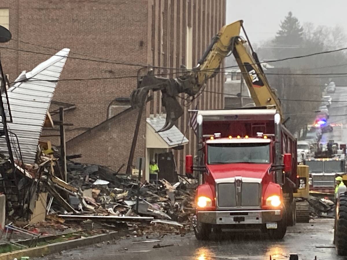 Rubble is cleared at the site of a deadly explosion at a chocolate factory in West Reading, Pa. ...