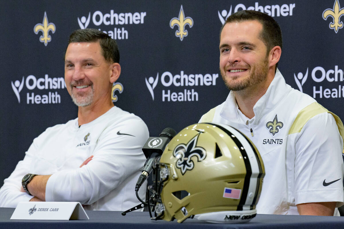Derek Carr, right, smiles as he is introduced as the new quarterback of the New Orleans Saints ...