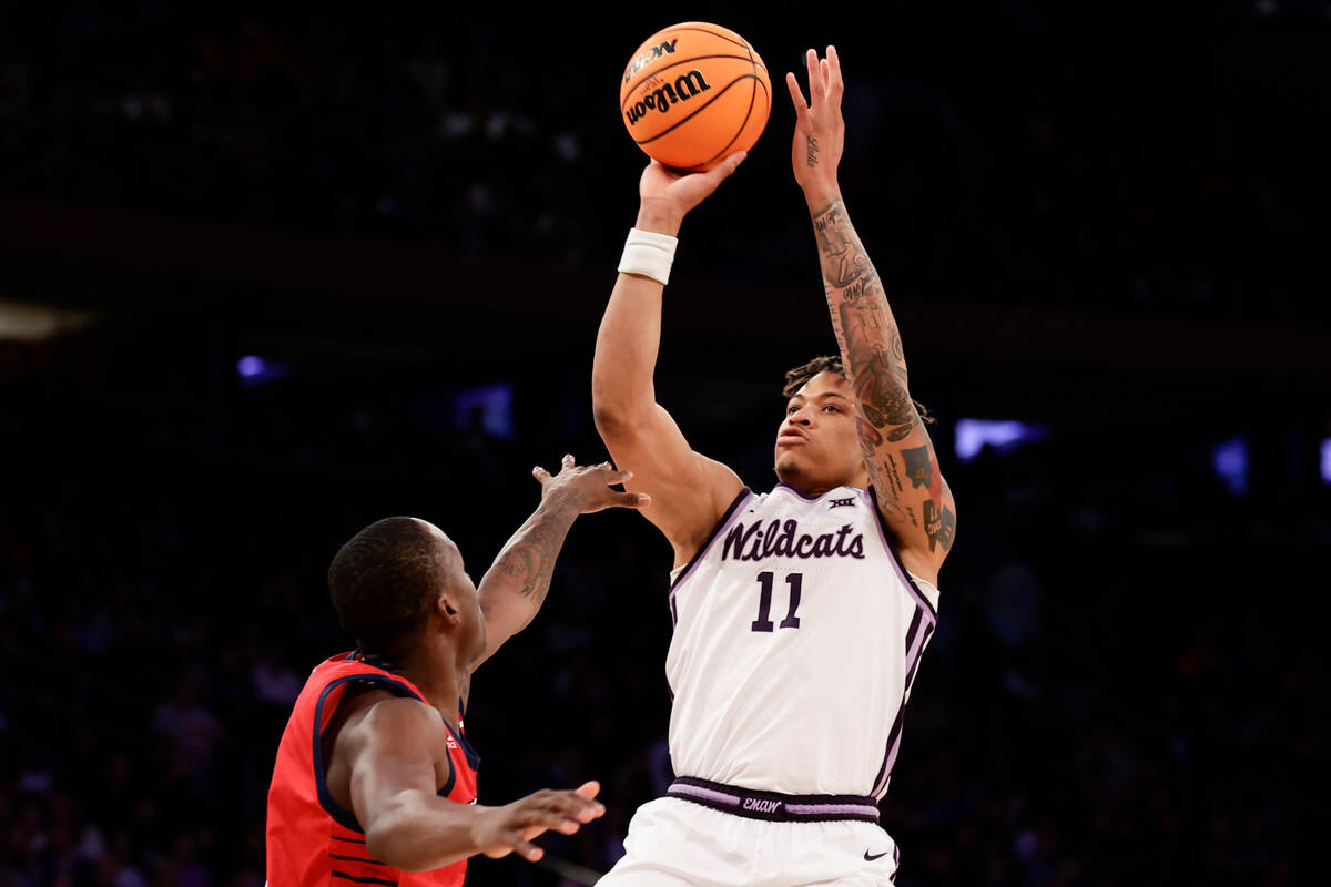 Kansas State's Keyontae Johnson (11) takes a shot in the first half of an Elite 8 college baske ...