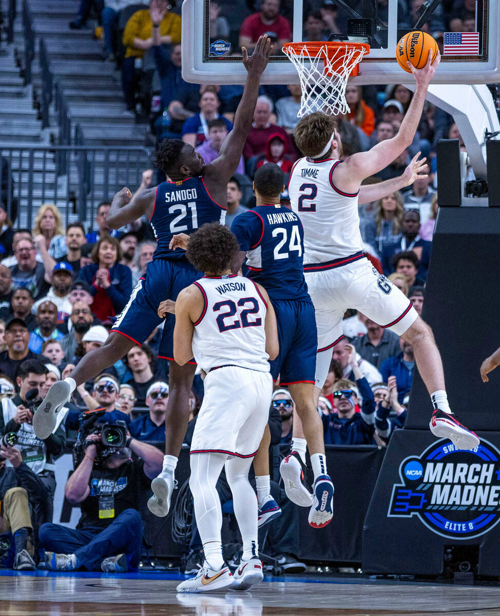 Gonzaga forward Drew Timme (2) gets inside for a basket over UConn forward Adama Sanogo (21) du ...