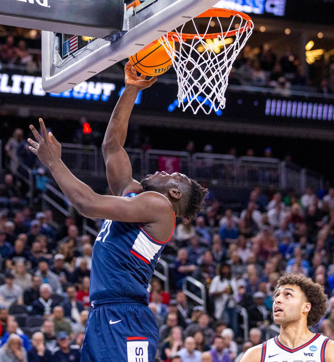 UConn forward Adama Sanogo (21) lays in the ball over Gonzaga forward Anton Watson (22) during ...