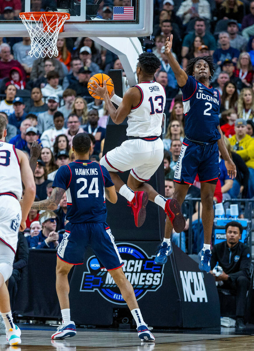 Gonzaga guard Malachi Smith (13) catches air to the hoop past UConn guard Tristen Newton (2) du ...