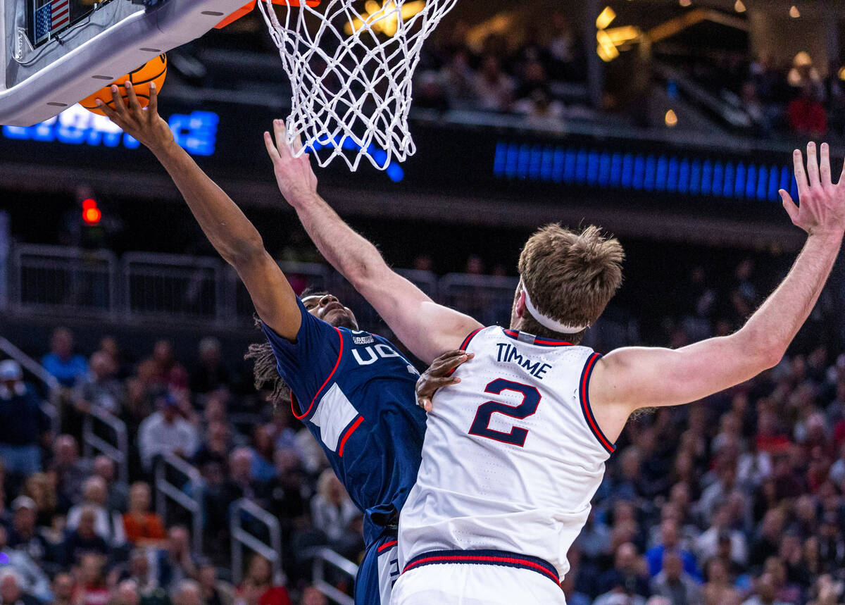 UConn guard Tristen Newton (2) gets inside of Gonzaga forward Drew Timme (2) for a basket durin ...