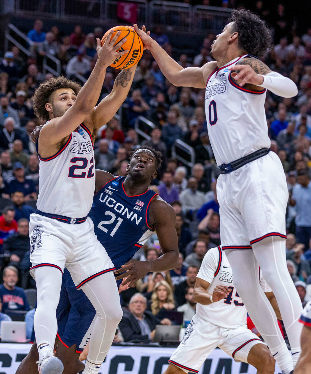 Gonzaga forward Anton Watson (22) and guard Julian Strawther (0) team up for a rebound over UCo ...