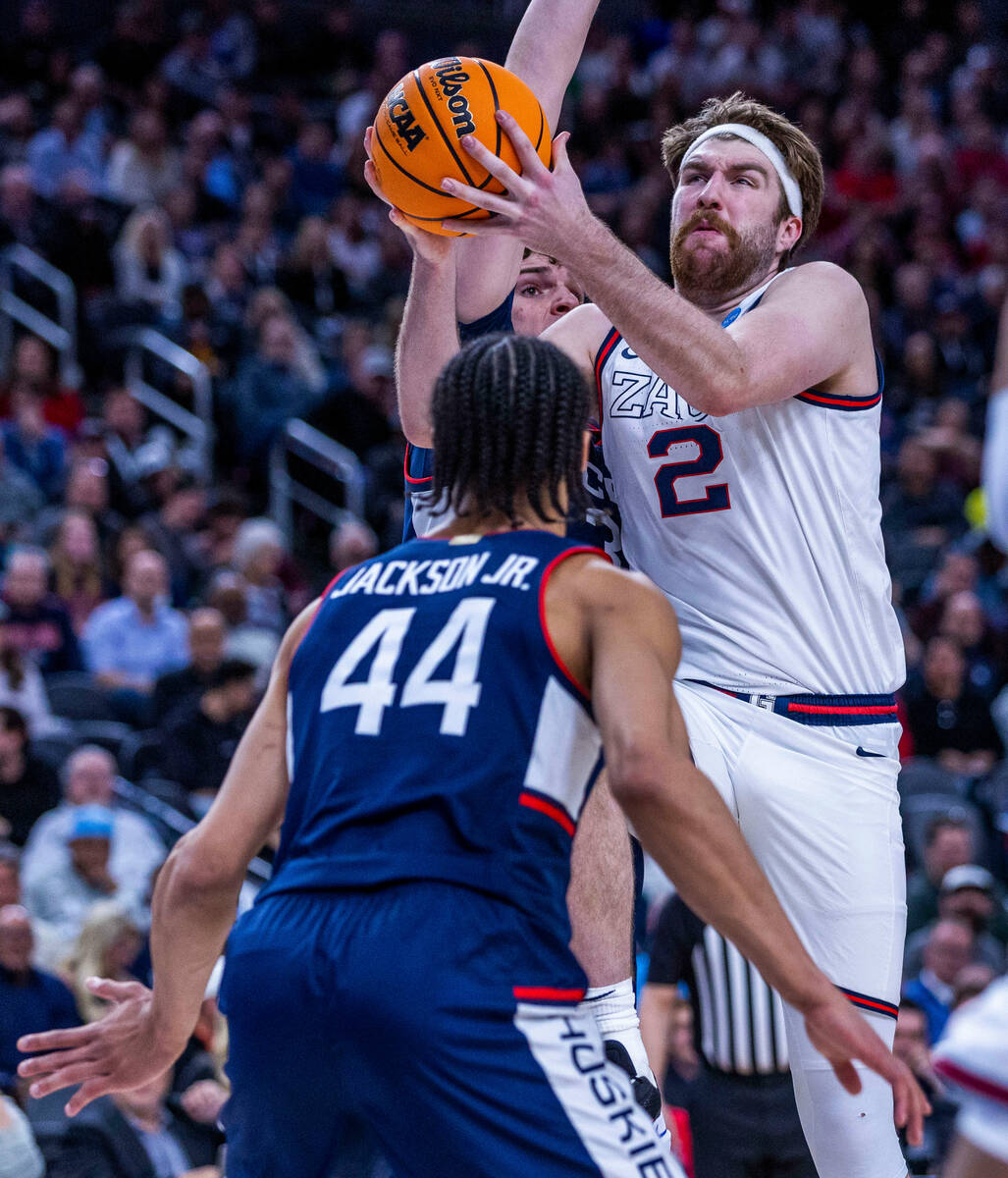 Gonzaga forward Drew Timme (2) drives hard to the basket against UConn guard Andre Jackson Jr. ...