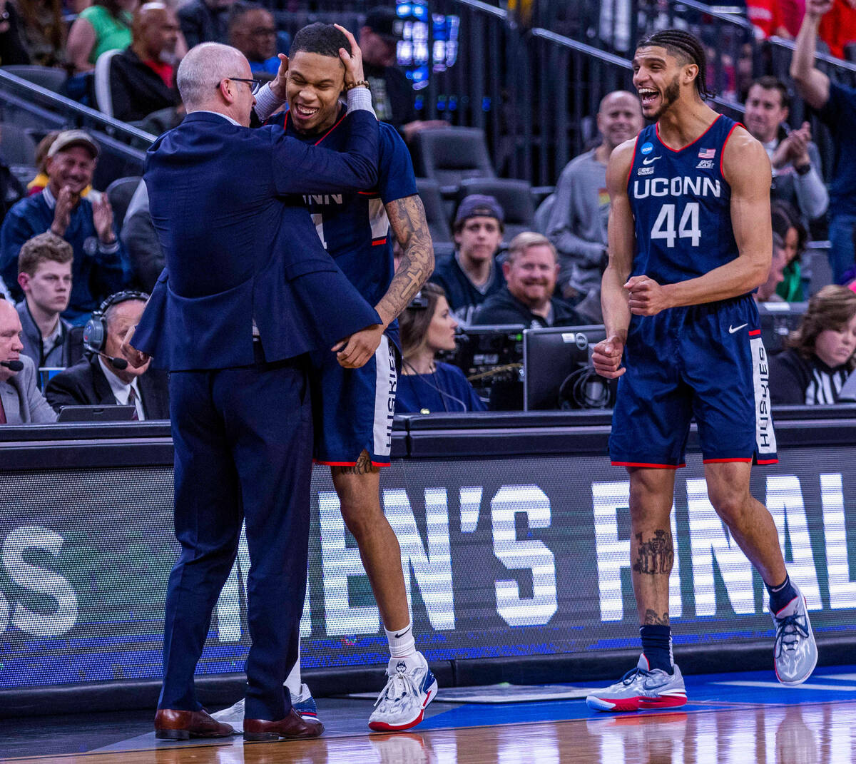 UConn head coach Dan Hurley congratulates guard Nahiem Alleyne (4) with guard Andre Jackson Jr. ...