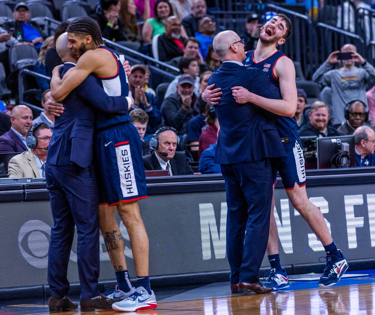 UConn head coach Dan Hurley, right, hugs forward Alex Karaban (11) as guard Andre Jackson Jr. ( ...