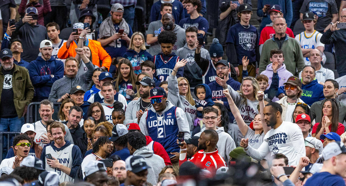 UConn fans congratulate their players after defeating Gonzaga in their West Regional Elite 8 ga ...