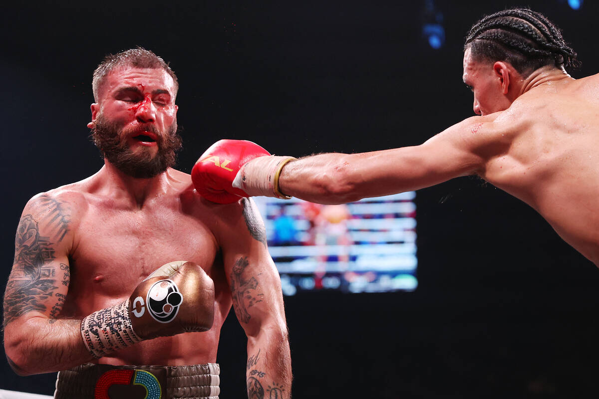 David Benavidez, right, connects a punch against Caleb Plant in the interim super middleweight ...