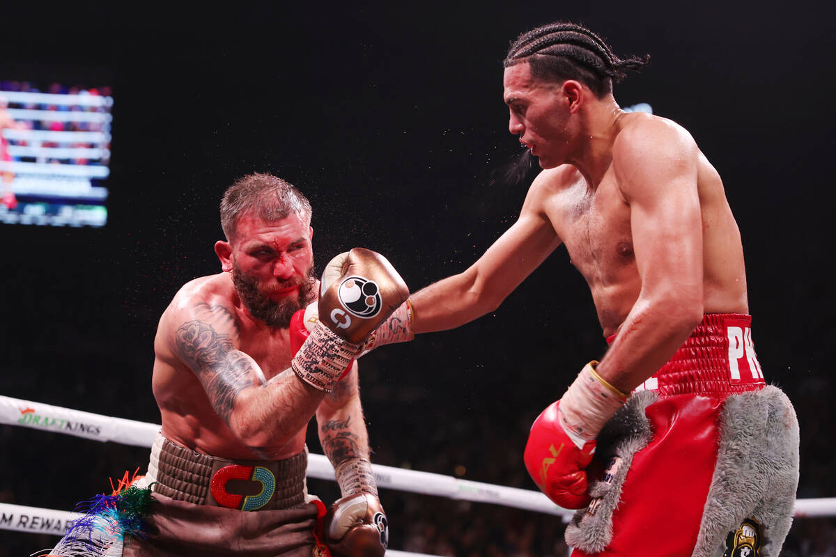 David Benavidez, right, throws a punch against Caleb Plant in the interim WBC world super middl ...