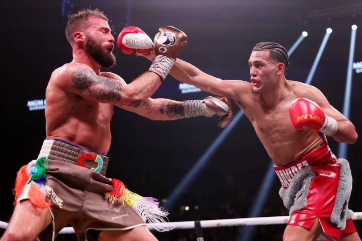 David Benavidez, right, connects a punch against Caleb Plant in the interim WBC world super mid ...