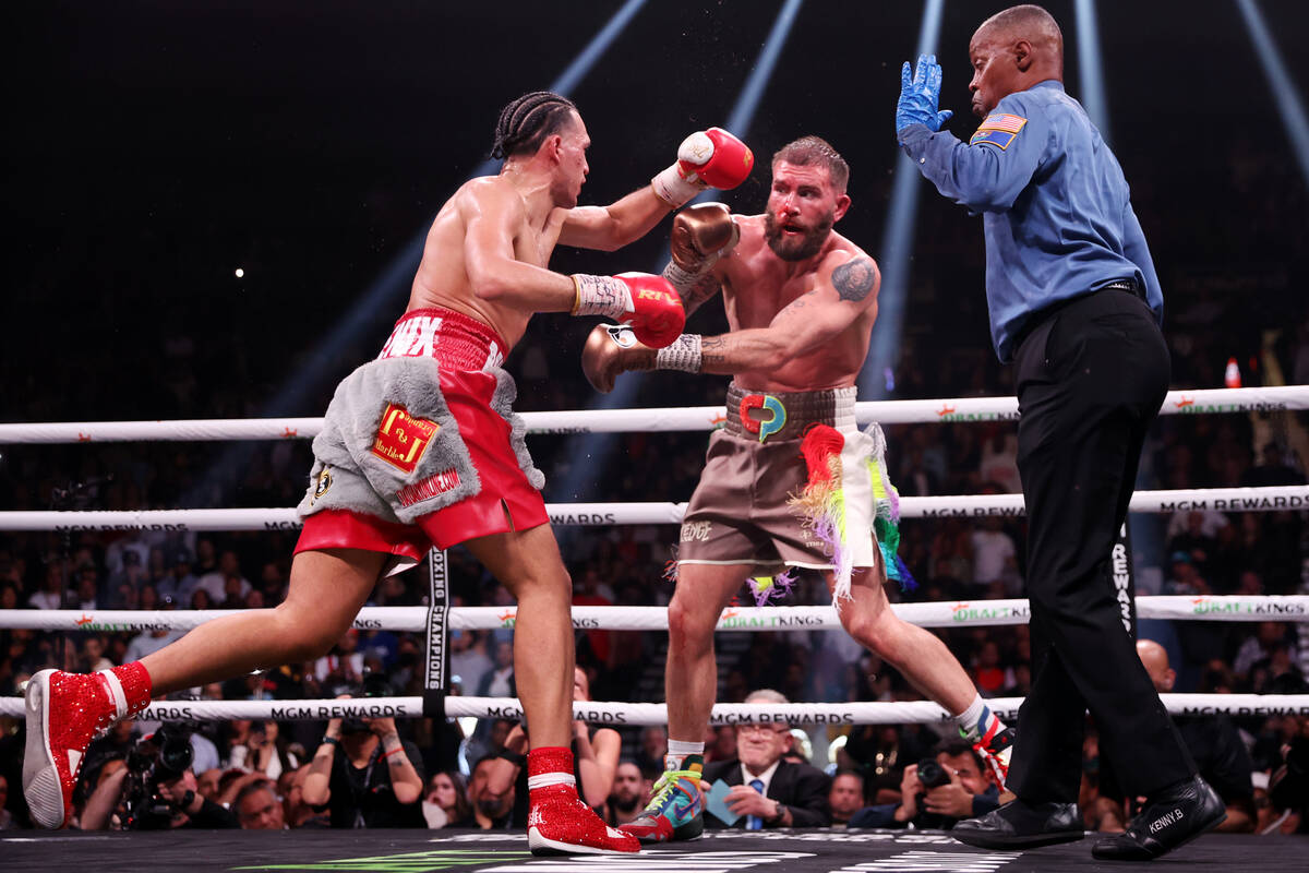 David Benavidez, left, throws a punch against Caleb Plant in the interim WBC world super middle ...