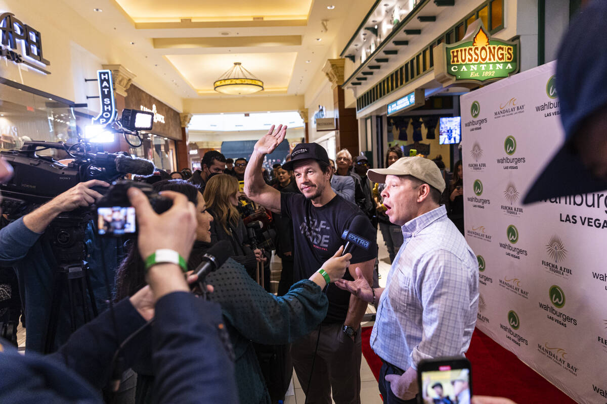 Brothers Mark Wahlberg, center, and Paul Wahlberg, right, are interviewed during the opening ce ...
