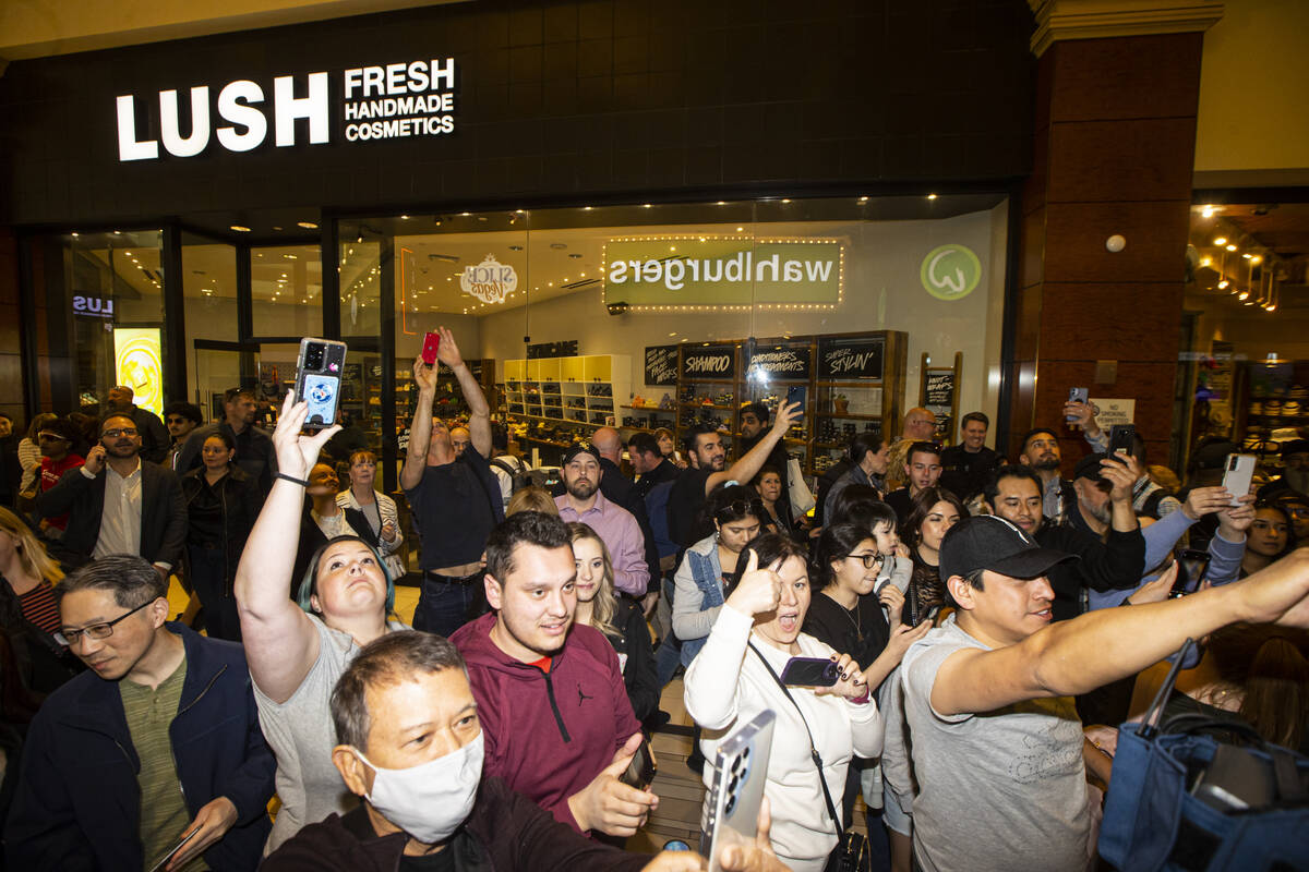 People record and look on as Mark Wahlberg arrives for the opening celebration of a new Wahlbur ...