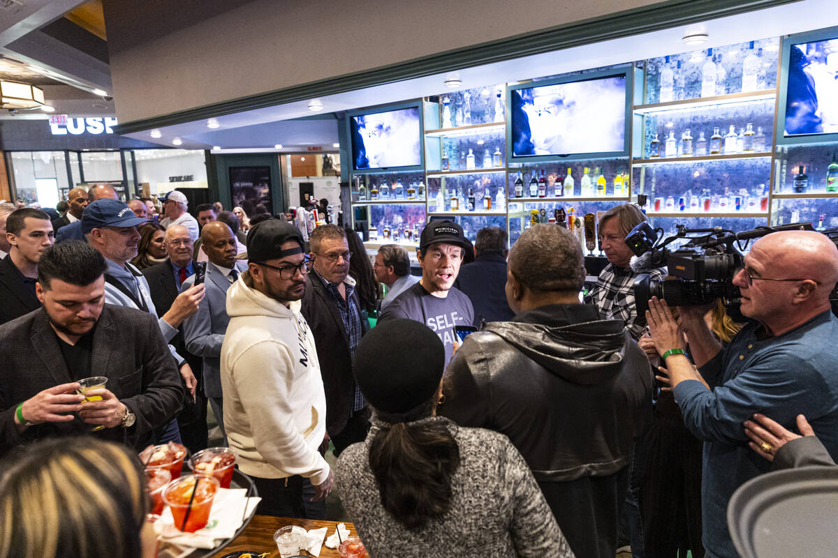 Mark Wahlberg, center, greets people during the opening celebration of a new Wahlburgers at The ...