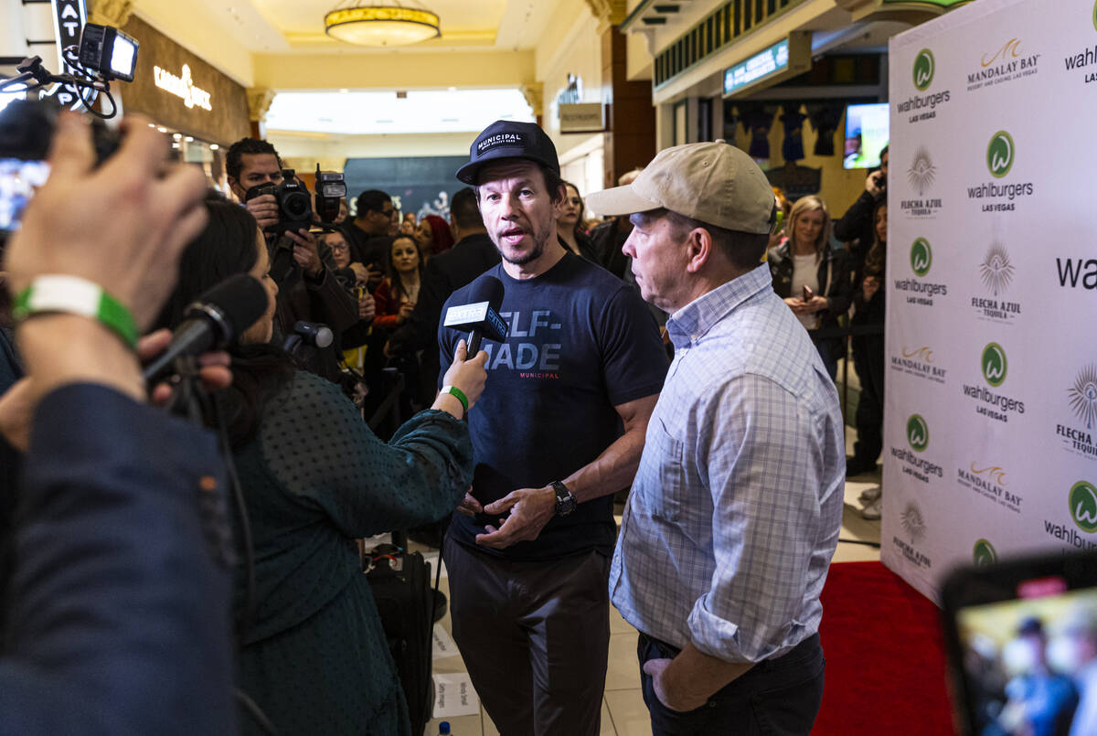Brothers Mark Wahlberg, center, and Paul Wahlberg, right, are interviewed during the opening ce ...