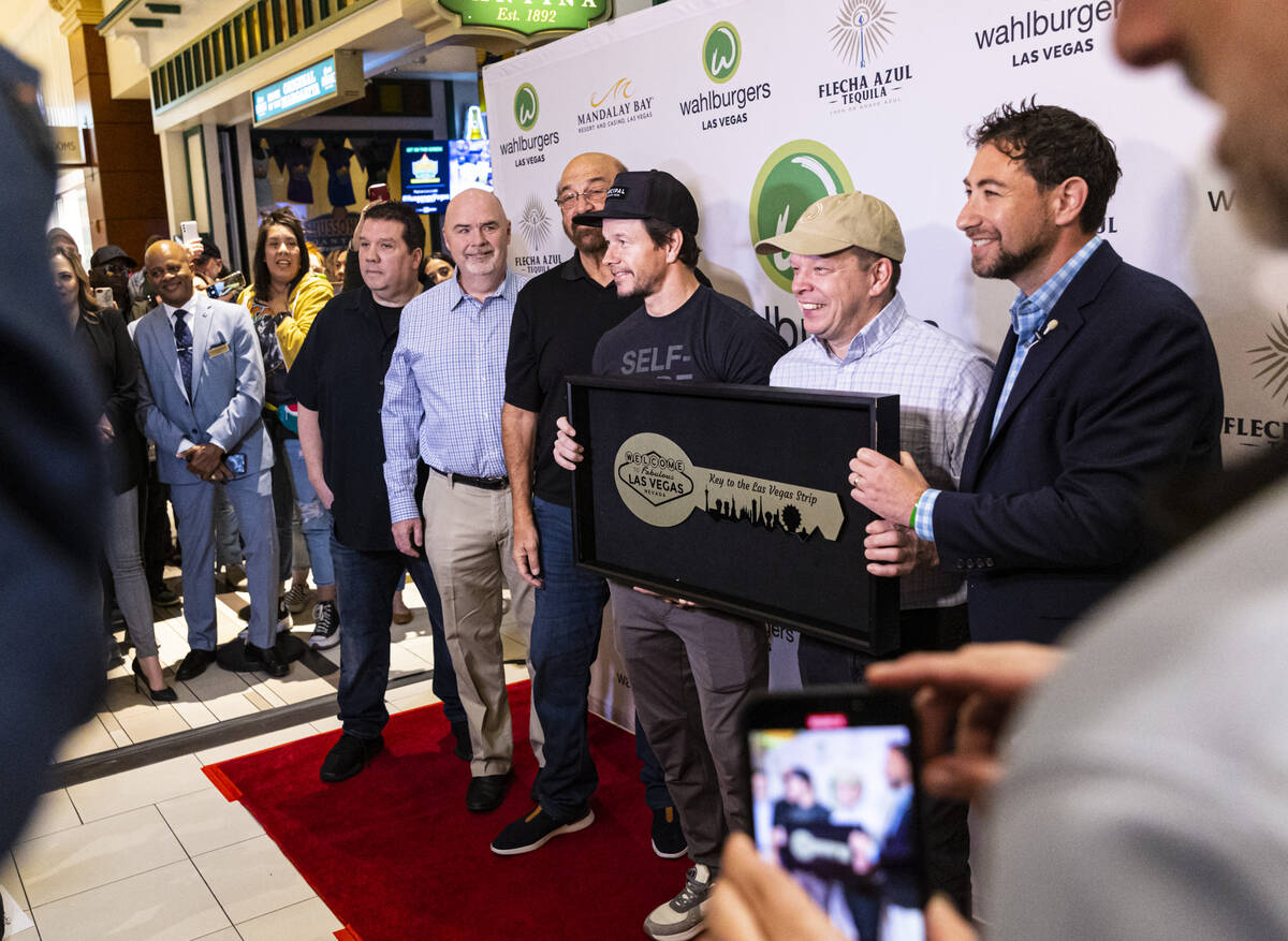 Clark County Commissioner Michael Naft, right, presents brothers Mark Wahlberg and Paul Wahlber ...