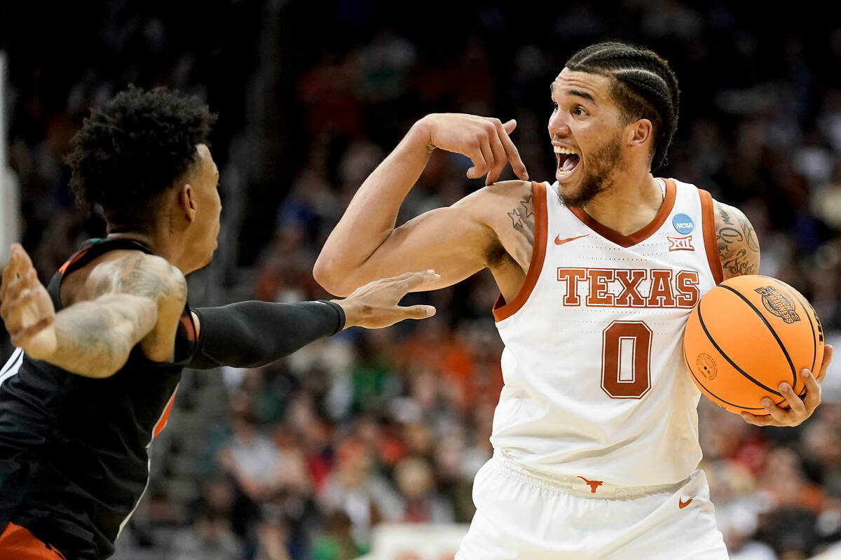 Texas forward Timmy Allen yells in the first half of an Elite 8 college basketball game against ...