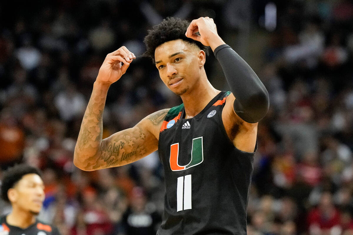 Miami guard Jordan Miller celebrates after scoring against Texas in the second half of an Elite ...