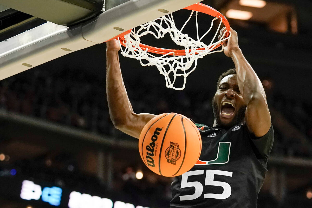 Miami guard Wooga Poplar dunks against Texas in the second half of an Elite 8 college basketbal ...
