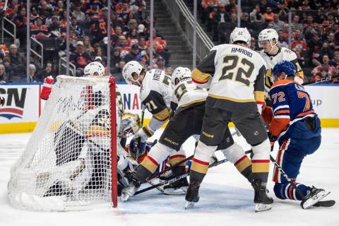Vegas Golden Knights goalie Laurent Brossoit (39) makes a save and is pushed into the net durin ...