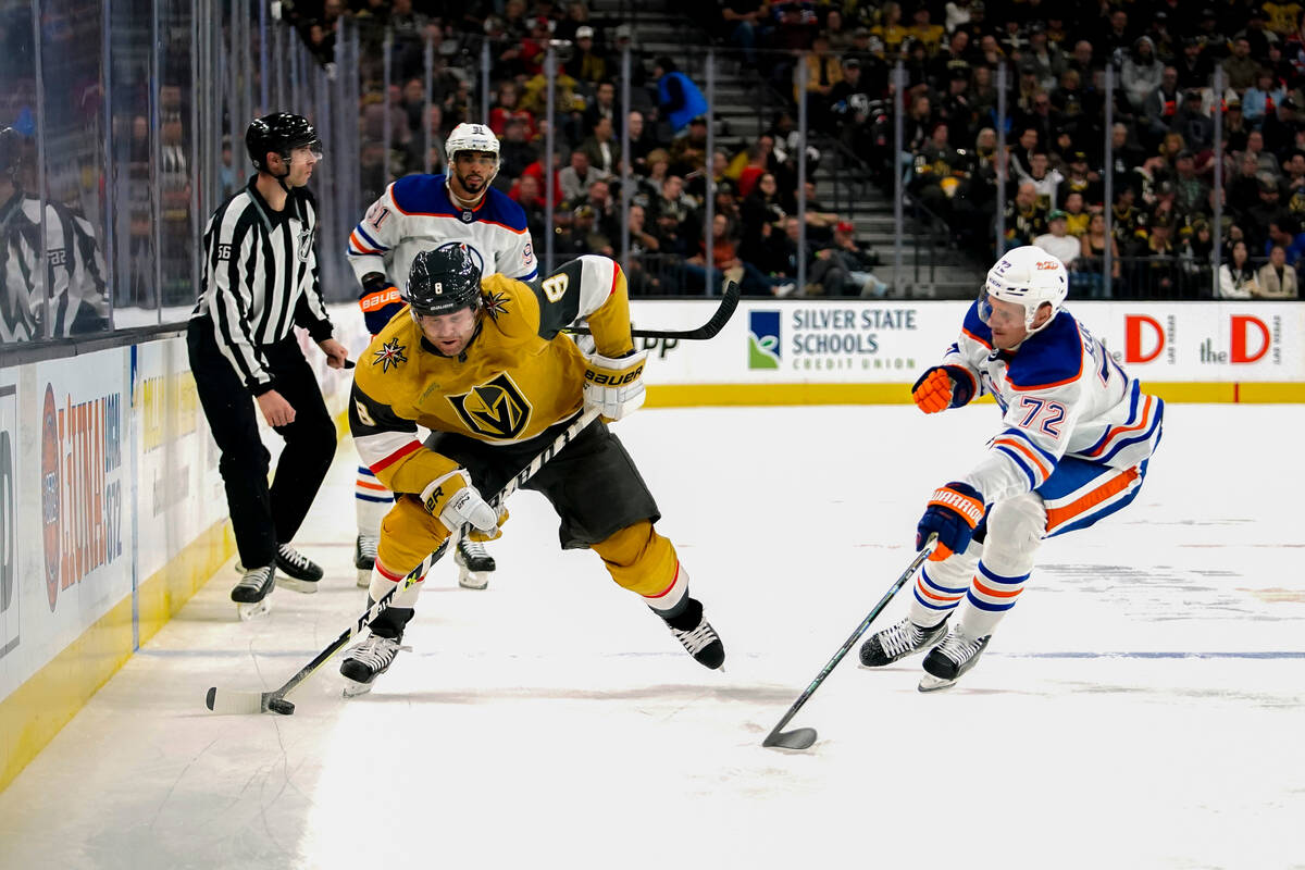 Vegas Golden Knights center Phil Kessel (8) skates with the puck next to Edmonton Oilers center ...