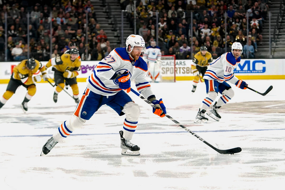 Edmonton Oilers defenseman Brett Kulak (27) skates with the puck during the third period of the ...