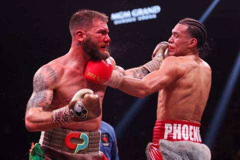 David Benavidez, right, connects a punch against Caleb Plant in the interim WBC world super mid ...