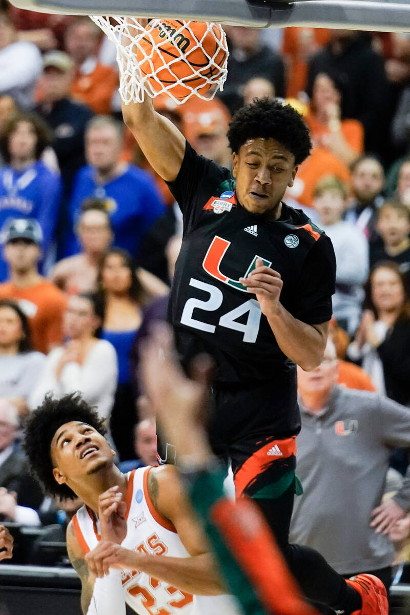 Miami guard Nijel Pack dunks over Texas forward Dillon Mitchell in the second half of an Elite ...