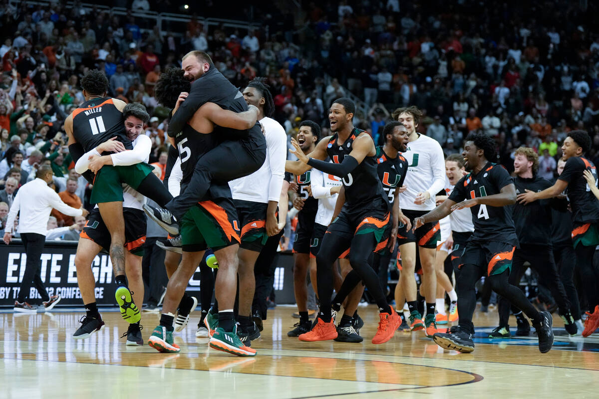 Miami celebrates after their win against Texas in an Elite 8 college basketball game in the Mid ...