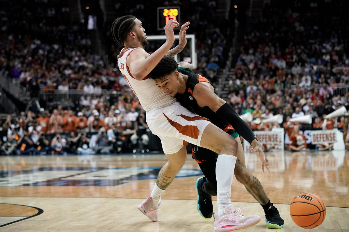 Miami guard Jordan Miller drives to the basket past Texas forward Timmy Allen in the second hal ...