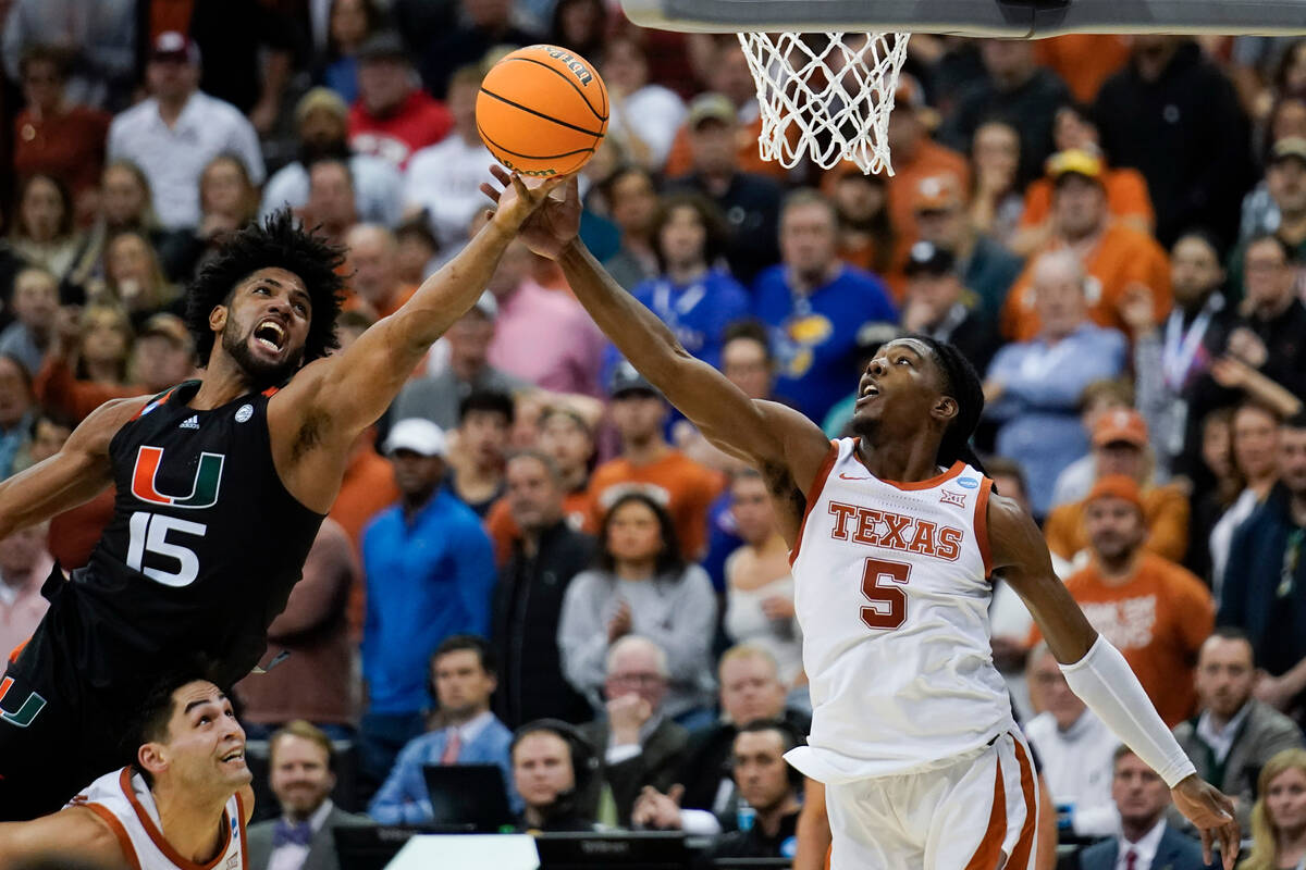 Miami forward Norchad Omier shoots over Texas guard Marcus Carr in the second half of an Elite ...