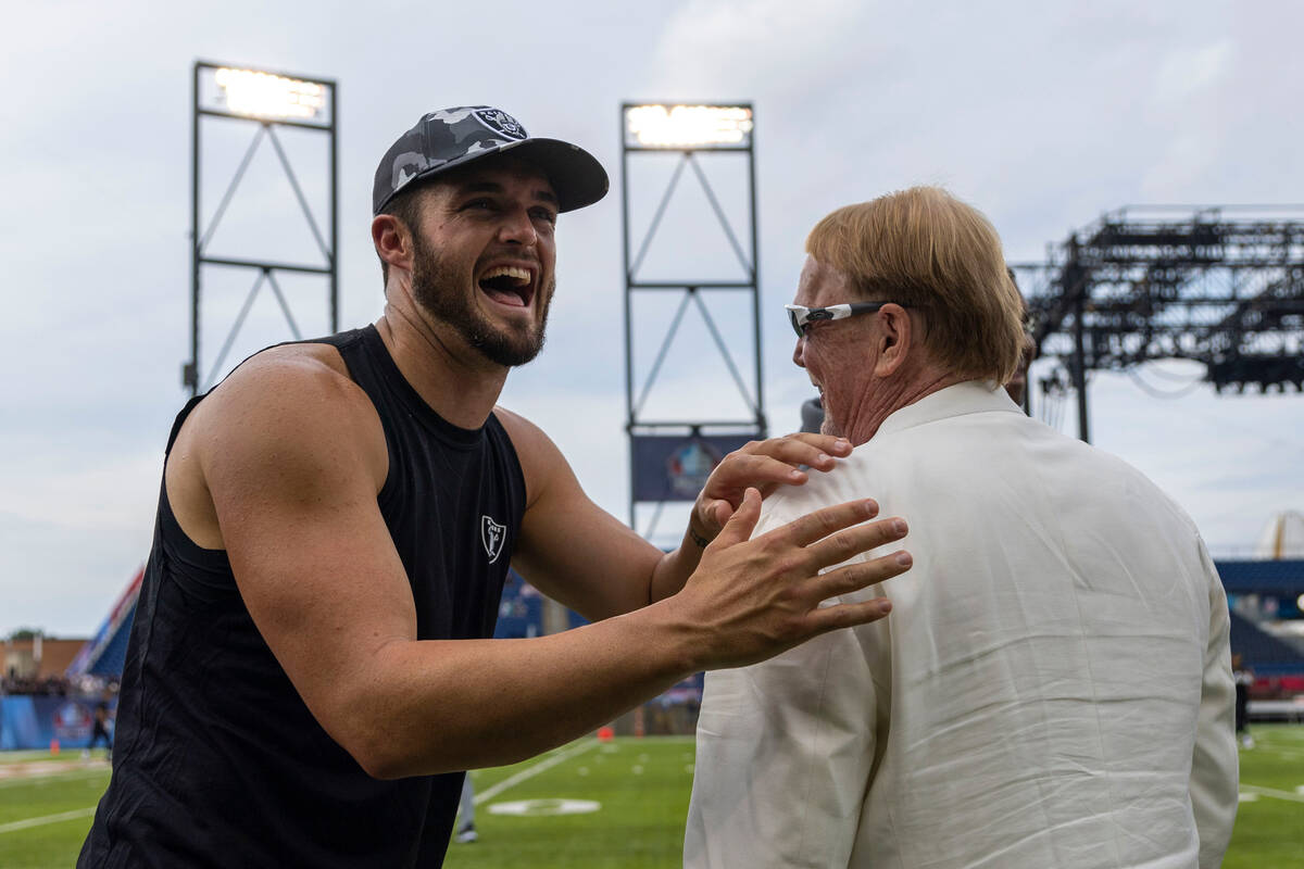 Raiders quarterback Derek Carr, left, shares a laugh with owner Mark Davis before the NFL Hall ...