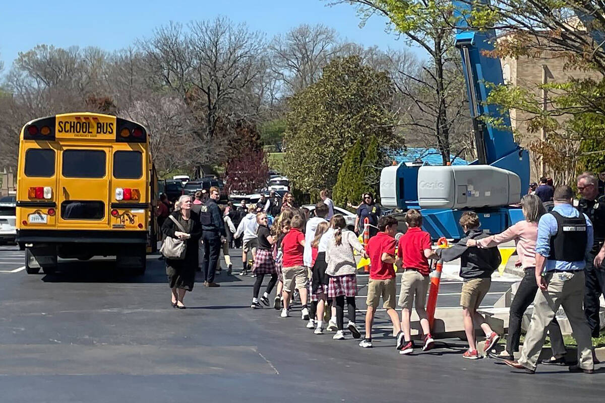 Children from The Covenant School, a private Christian school in Nashville, Tenn., hold hands a ...