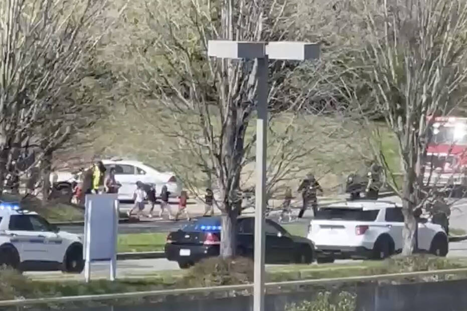 In this image from video provided by Jozen Reodica, law enforcement officers lead children away ...