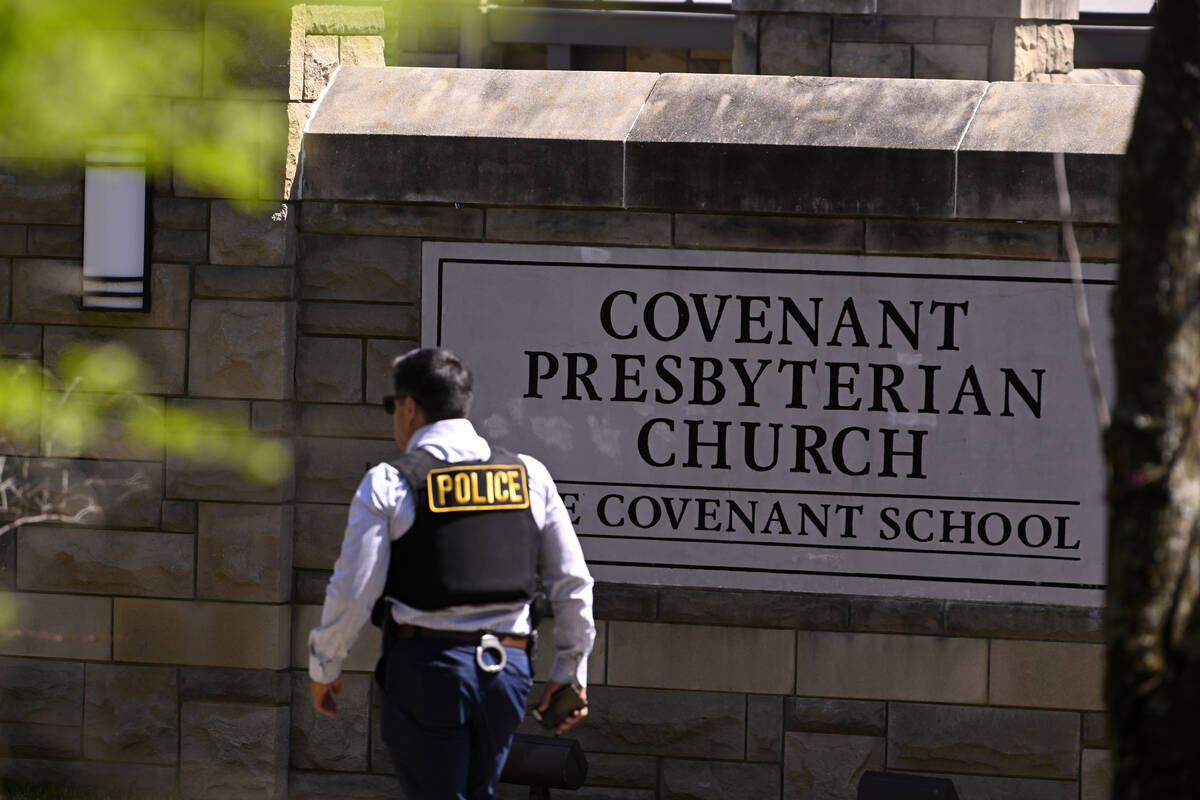 A police officer walks by an entrance to The Covenant School after a shooting in Nashville, Ten ...