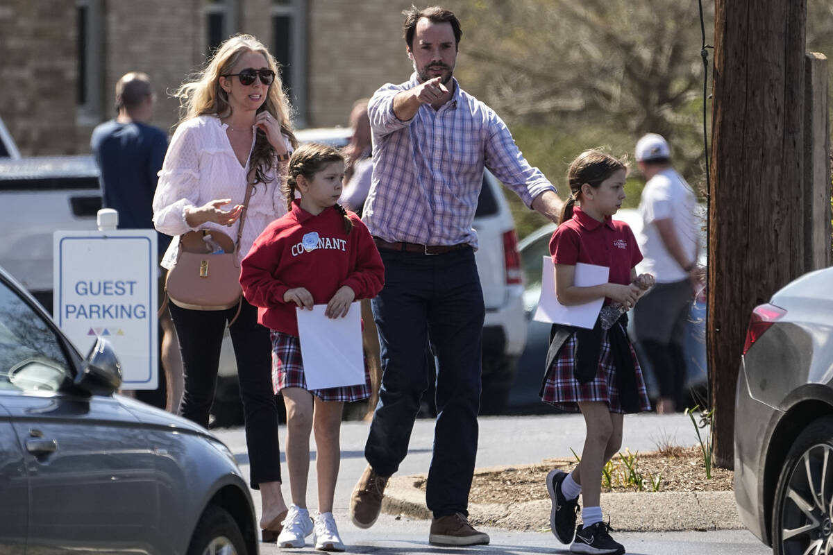 A family departs the reunification center at the Woodmont Baptist church after a school shootin ...