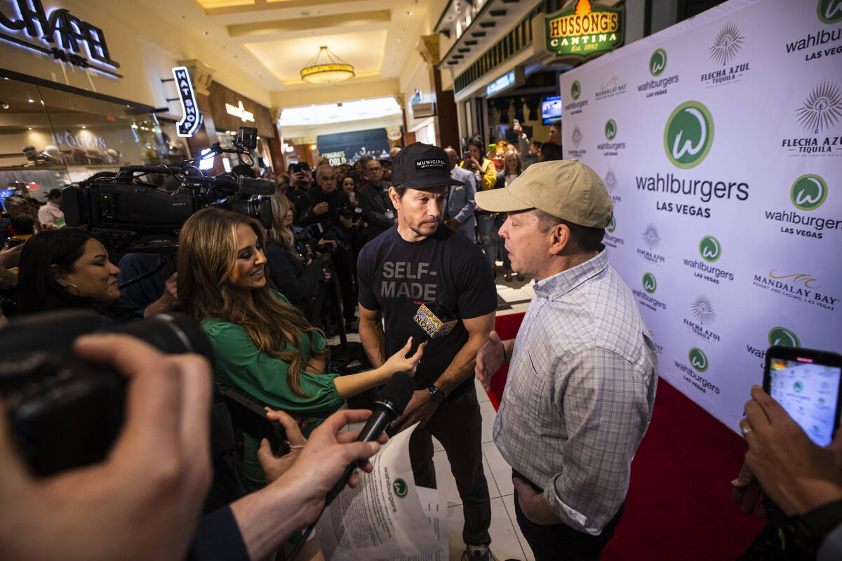 Brothers Mark Wahlberg, center, Paul Wahlberg, right, are interviewed during the opening celebr ...