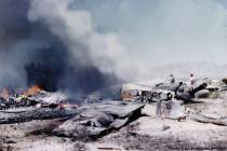 The wreckage of a United Airlines DC-7 smolders in the desert southwest of Las Vegas after a mi ...