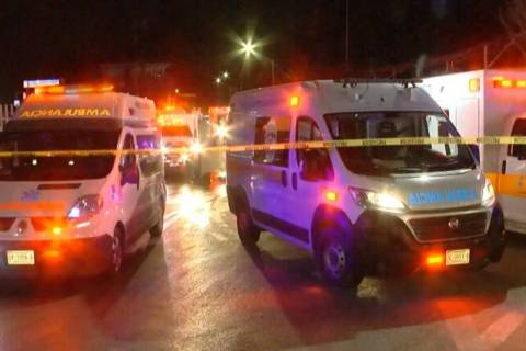 Ambulances and rescue teams staffers are seen outside an immigration center in Ciudad Juarez, M ...
