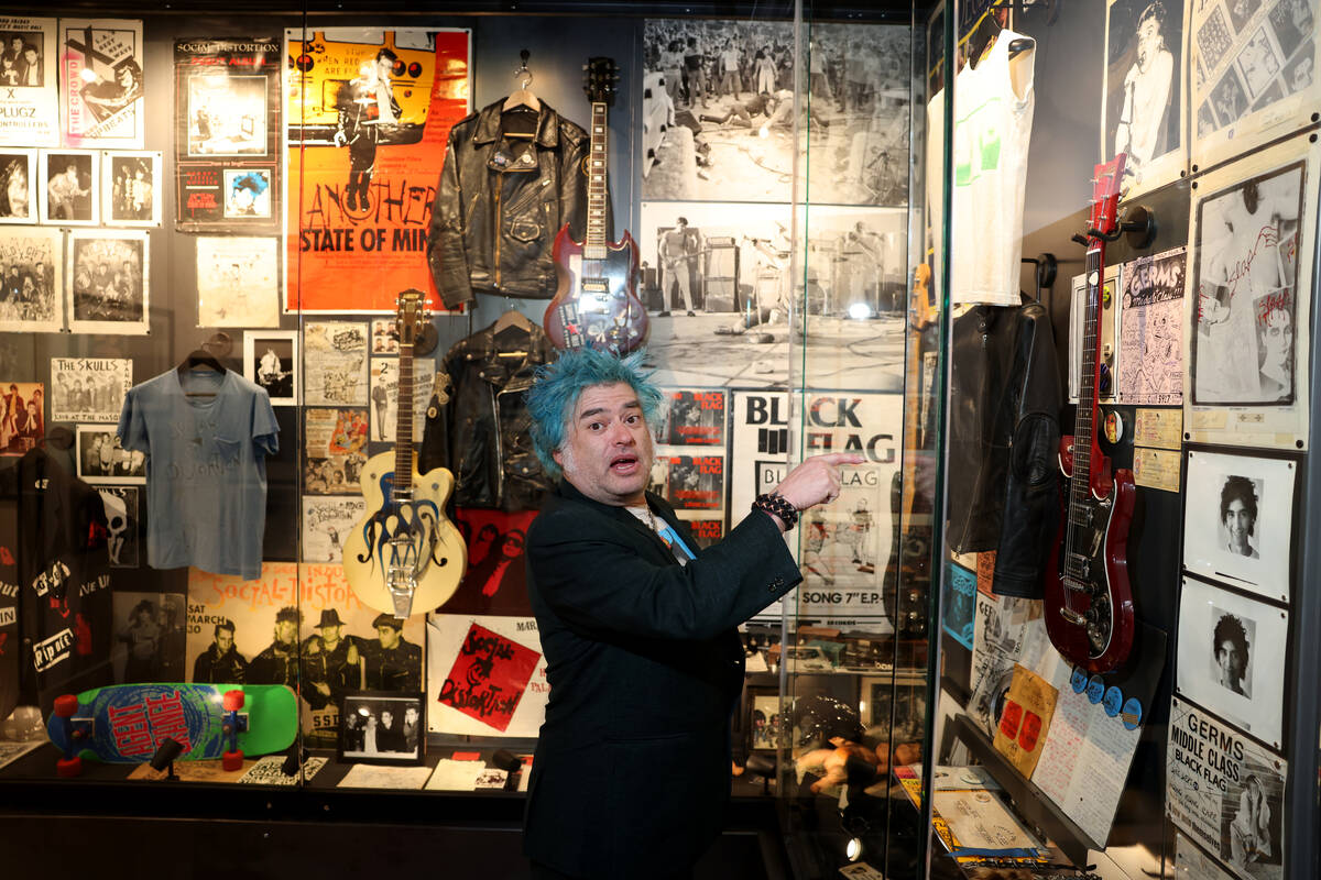 “Fat” Mike Burkett, co-founder of The Punk Rock Museum, shows Germs guitarist Pat ...