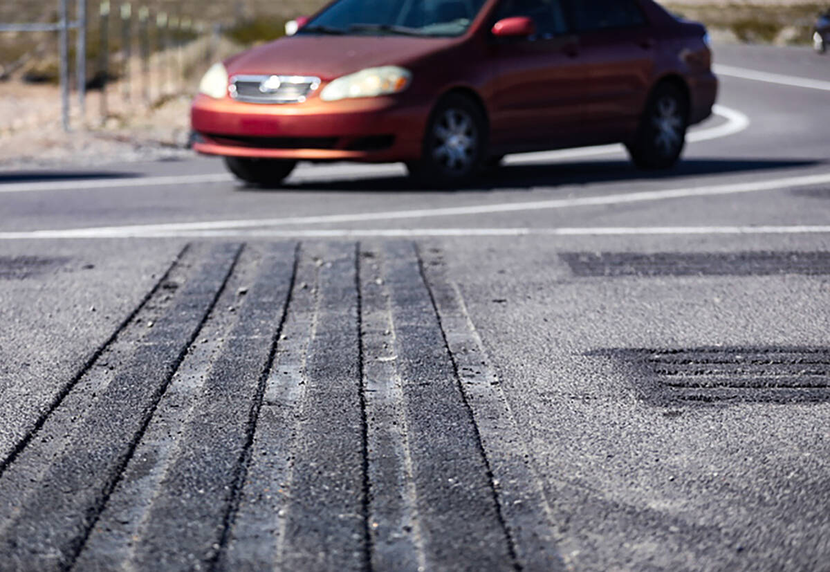 A motorist drives over a safety transverse rumble strip at the intersection of US 93 and Grand ...