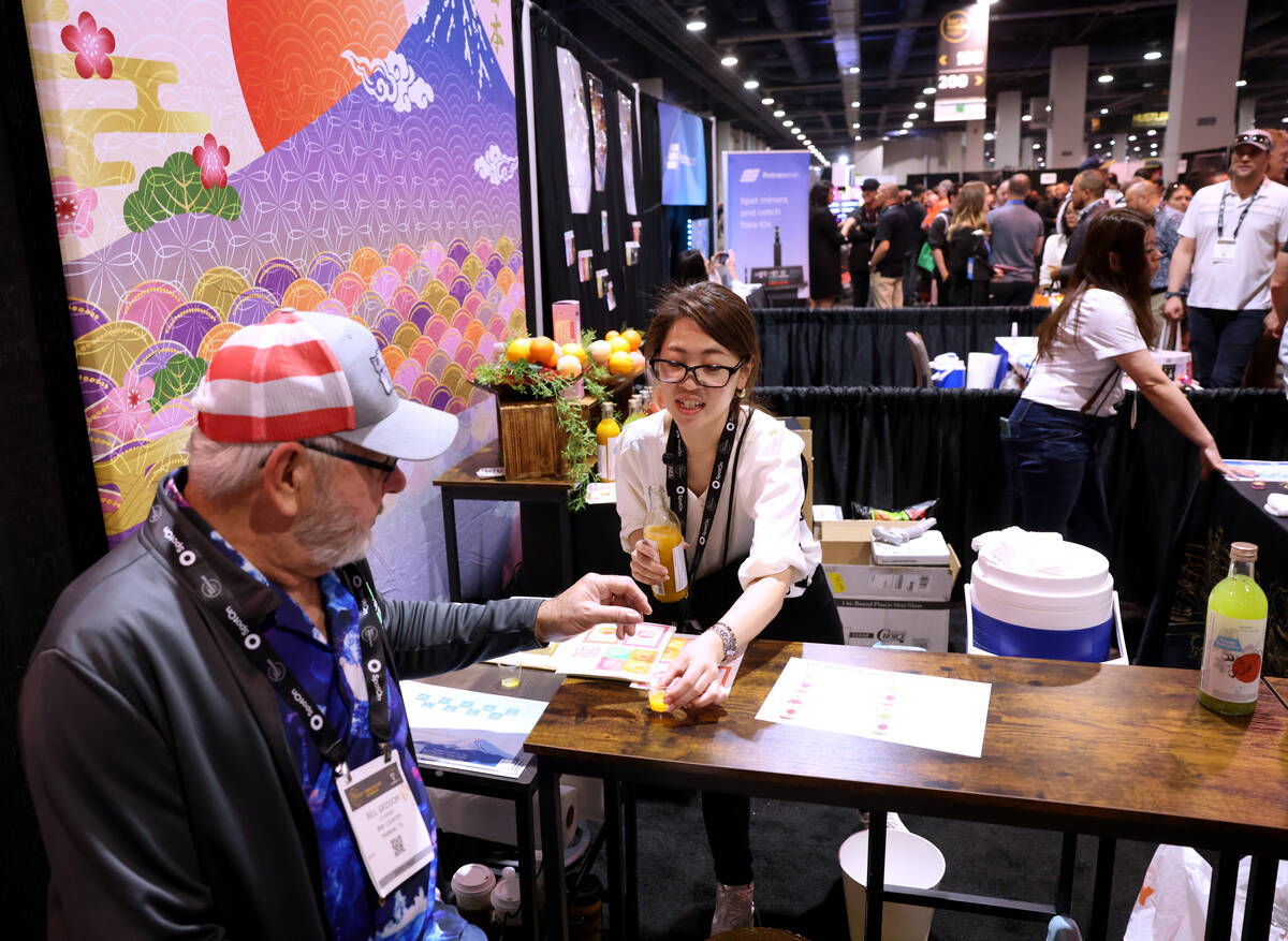 Kaori Tanaka with Kitaoka-Honten Co. from Japan gives samples to conventioneers, including Bill ...