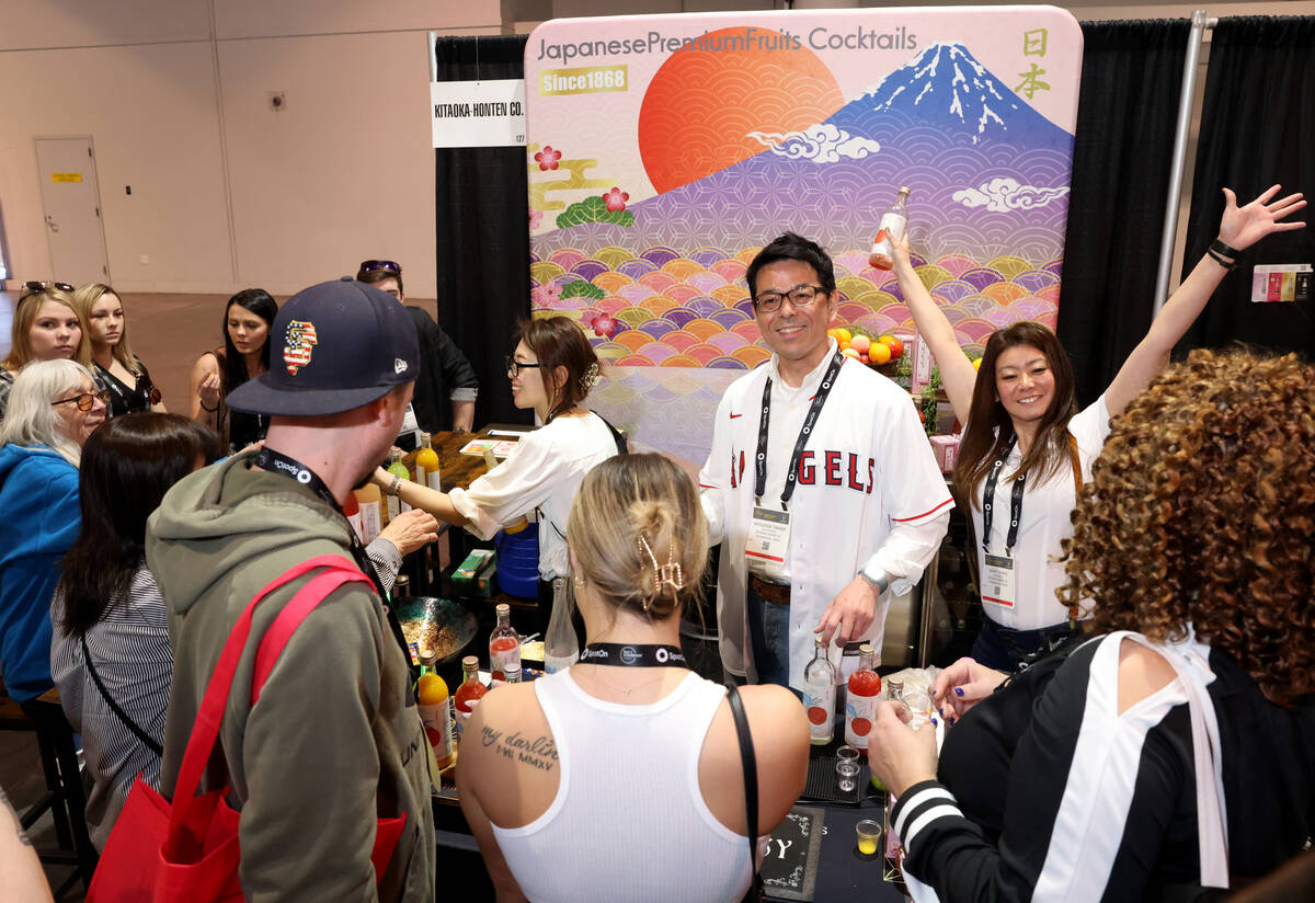 Katsuhisa Takada of Kitaoka-Honten Co. from Japan, center, gives samples to conventioneers at t ...