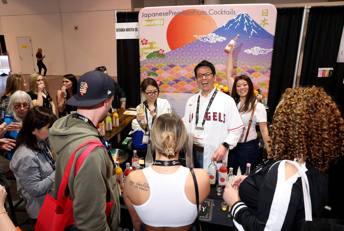 Katsuhisa Takada of Kitaoka-Honten Co. from Japan, center, gives samples to conventioneers at t ...