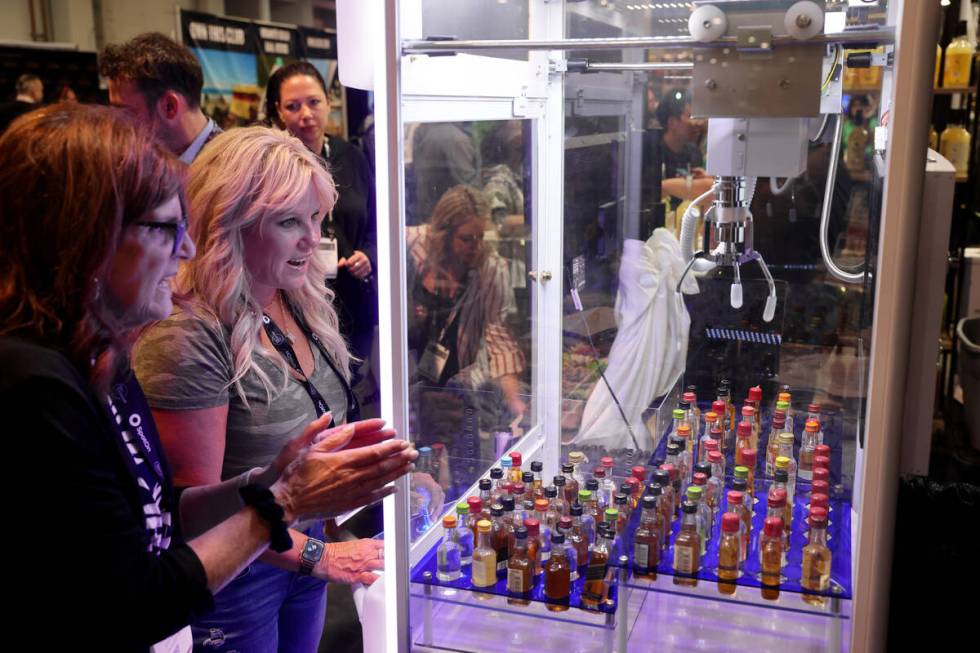 Ann Berger with Cocktail Claw of Oakwood, Ohio, left, shows her company’s product to con ...