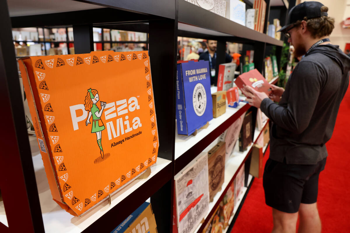 Jude Hiltner of Rafferty's Pizza in Pequot Lakes, Minn. checks out pizza boxes on display at th ...