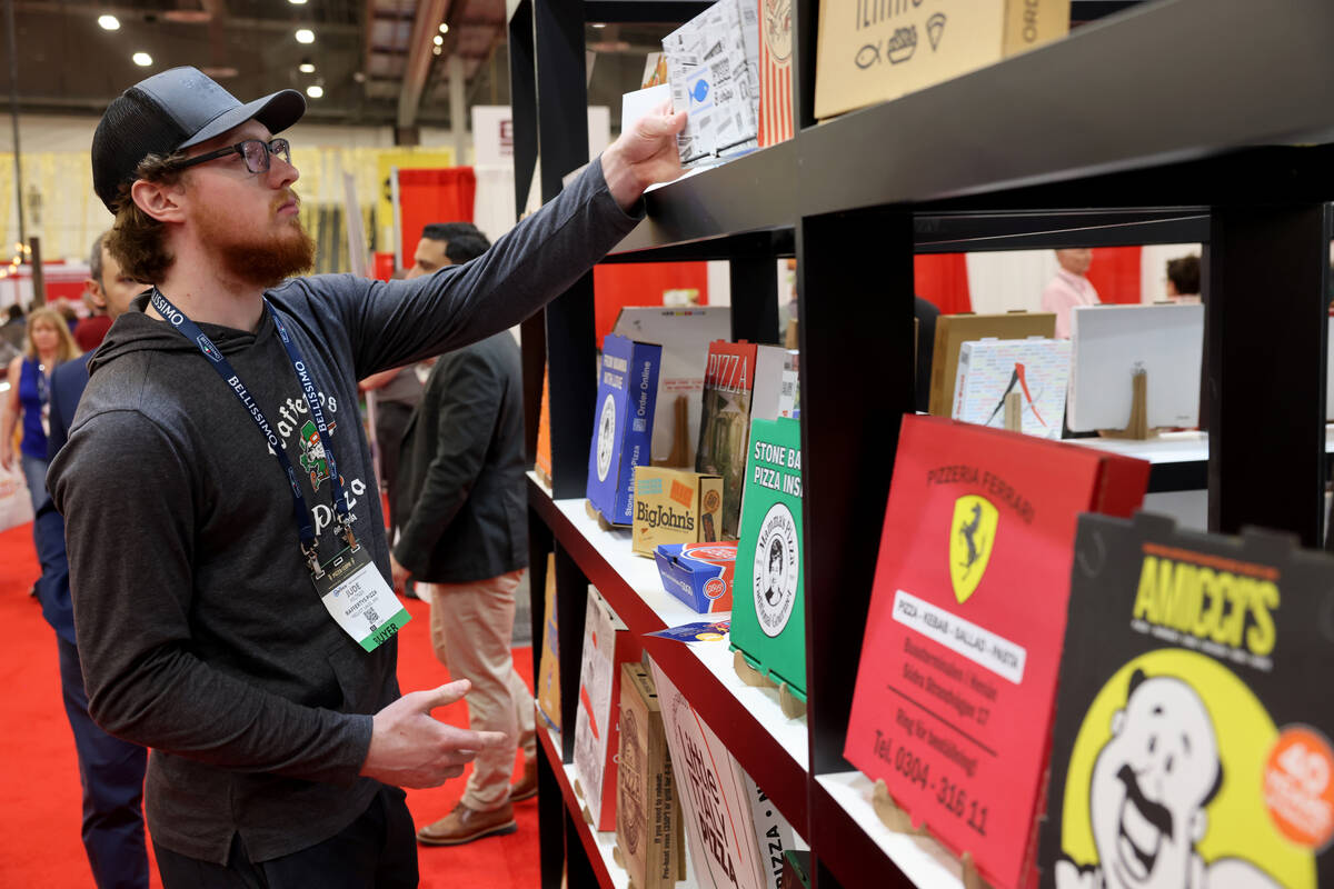 Jude Hiltner of Rafferty's Pizza in Pequot Lakes, Minn. checks out pizza boxes on display at th ...