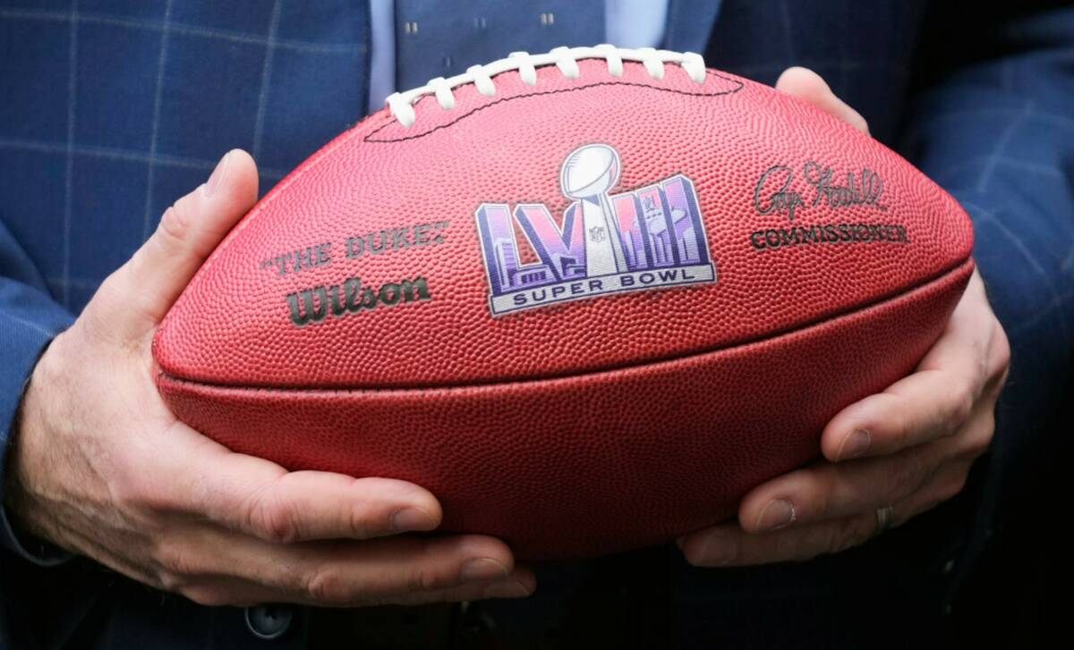 Gov. Joe Lombardo holds an NFL football with the Super Bowl LVIII logo in February 2023. (AP Ph ...