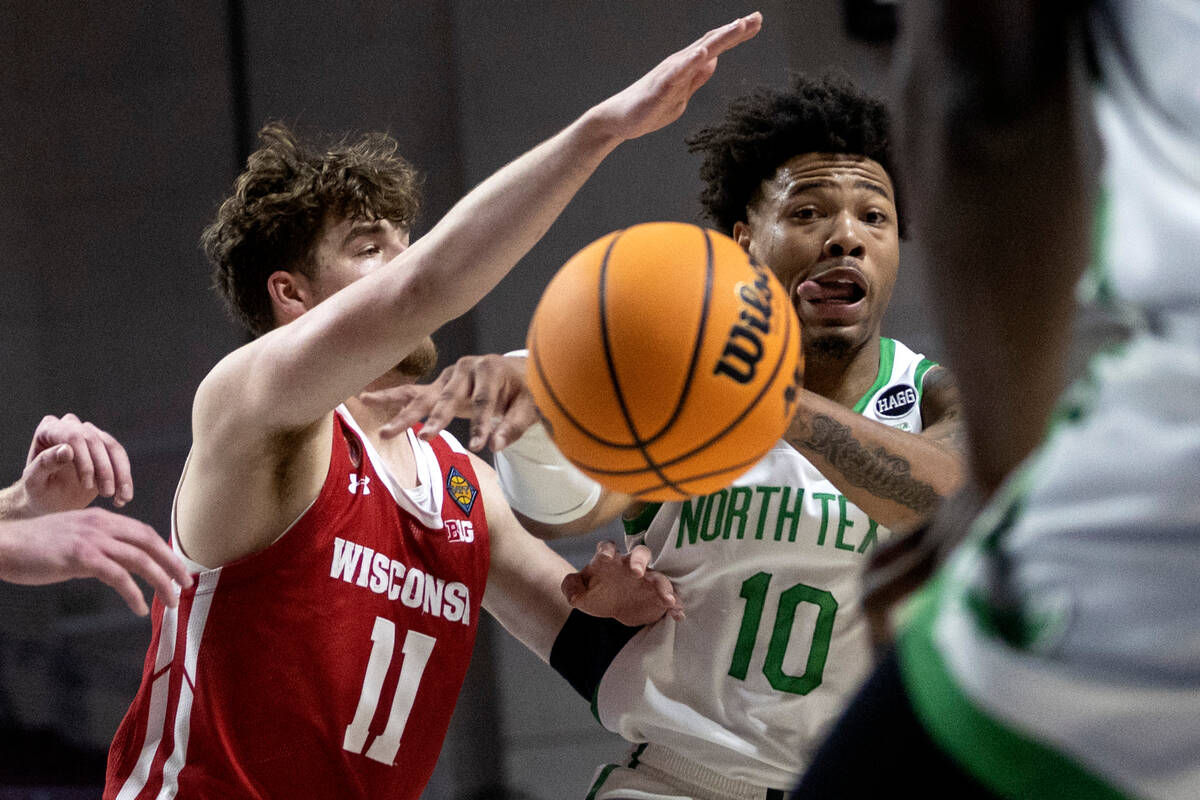 North Texas Mean Green guard Kai Huntsberry (10) passes while Wisconsin Badgers guard Max Klesm ...